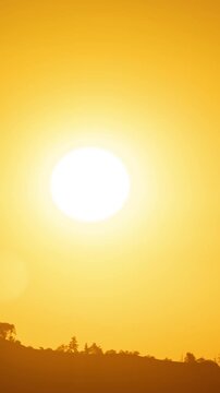 Time Lapse of the sun rising from behind the mountains in Los Angeles. Vertical Video.