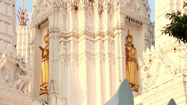 White Thai Chedi Towers with Golden Buddha Statues at Mahathat temple Thailand.