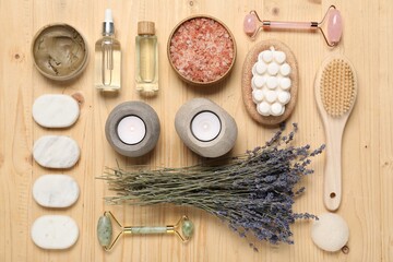 Flat lay composition with spa essentials on wooden background