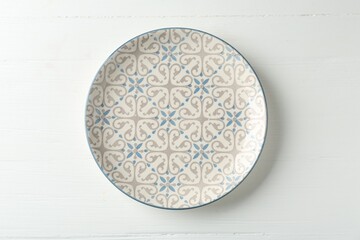 Empty ceramic plate on white wooden table, top view