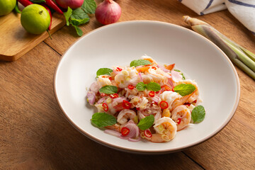 Spicy Lemongrass Salad with Shrimps in white plate.Thai food.