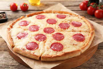 Delicious pepperoni pizza on wooden table, closeup
