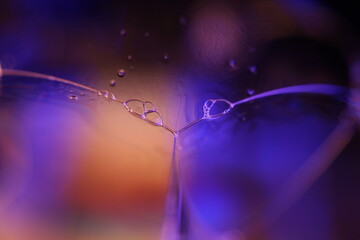 Purple and green liquid film, fluid background, flat waves, glowing elements, illuminated chemical effects