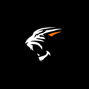 Silhouette of a snarling feline in white and orange on a solid black background