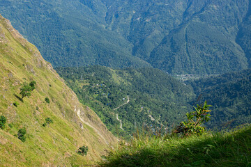 Obraz premium View of Himalayan mountain and forest from Tarey Bhir point, tourist spot, Sikkim, India. 'Bhir' means cliff in the local Nepal language,about 10,000 feet long path, a breathtaking view at the edge.