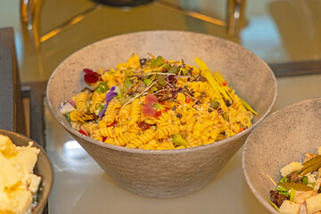 Large Bowl Full of Italian Pasta Salad at Buffet Table