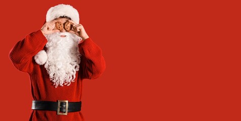 Santa Claus holding sweet cookies on red background with space for text