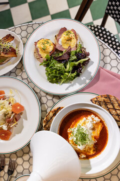 brunch at a moroccan theme restaurant with fusion shakshuka, eggs benedict, salad, and bread
