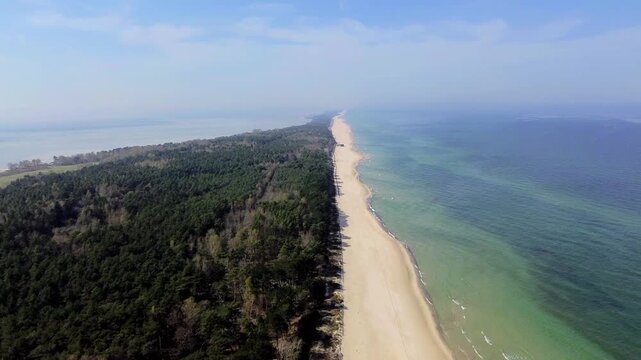 Hel, Poland. The long, narrow peninsula. Crystal-clear Baltic Sea, a shoreline with golden sand, along which a dense forest stretches.