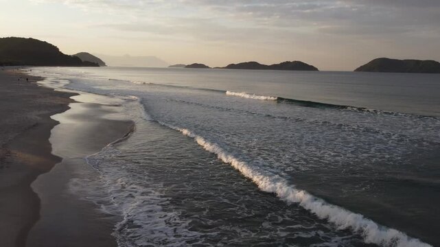 Beautiful sunrise on a tropical paradise beach with small waves in Juquehy
