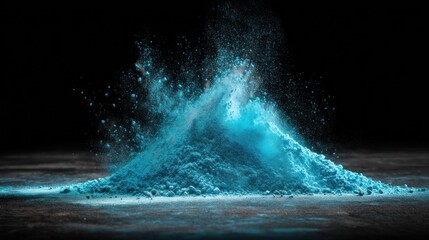 A pile of blue powder on a dark surface, with a dark background.