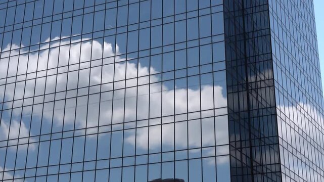 Modern architectural building with reflective glass facade and sky reflection