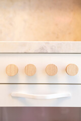 A compact and luxurious kitchen for children, with marble countertops and minimalist cabinets. Vibrant colors add playful elements to create a fun and functional space.