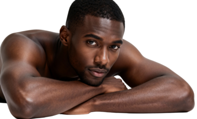 Confident young man with bare chest lying down, looking directly at the viewer., transparent background png