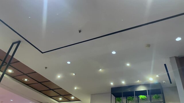 Low angle view of a modern ceiling design with recessed spotlights.