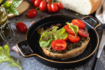Fresh mediterranean bruschetta with cherry tomatoes and basil on grilled bread.