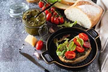 Fresh mediterranean bruschetta with cherry tomatoes and basil on grilled bread. Copy space.
