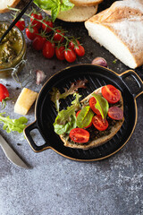 Fresh mediterranean bruschetta with cherry tomatoes and basil on grilled bread. Copy space.