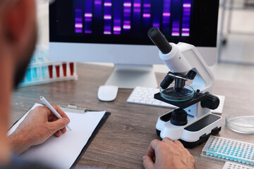 Research in genetics. Scientist working at table in laboratory, closeup