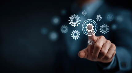 Businessmans hand pointing at a digital gear interface for business strategy