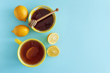 Flat Lay with Lemon Tea, Ginger and Honey on Blue Background