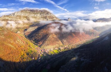 Aerial View of Misty Mountains and Autumn Forest Valley