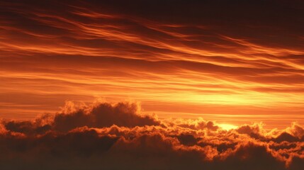 Naklejka premium A stunning sunset displays vibrant orange and red colors as the sun descends below the horizon. Soft clouds scatter the light creating a breathtaking evening scene.