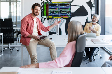 Business colleagues discussing financial data during meeting in office