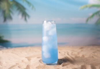 refreshing glass of icy blue beverage on sunlit sandy beach with ocean horizon and palm leaves under clear blue sky, holiday, refresh, exotic, coastline, calm, leisure, getaway, island, scenery