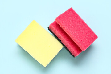 Cleaning sponges on blue background