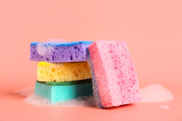 Cleaning sponges with foam on pink background