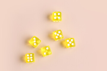 Yellow game dices on beige background