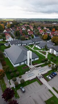 Aerial Freiberg Germany LDS Temple front circle vertical. The Church of Jesus Christ of Latter-day Saints, LDS or Mormon religion. Urban and rural neighborhood. Christian religious groups. European.