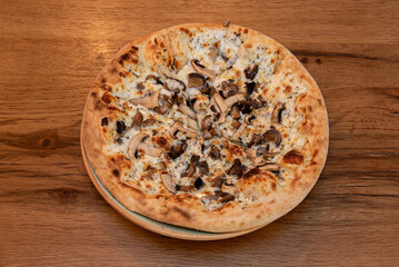 Truffle Pizza with black truffle sauce, sautéed mushrooms, and melted fontina che