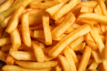 Texture of tasty french fries as background