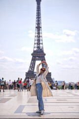 Tourist woman enjoying view of Eiffel Tower in Paris France