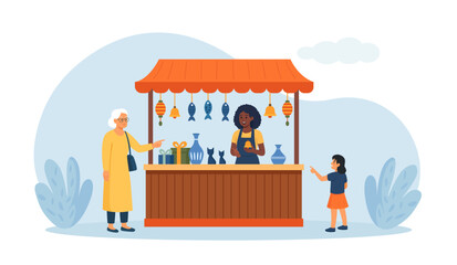 Souvenir shop with awning. Street market kiosk. Local outdoor fair. Antique store. Street stand with presents, gifts, decorative vases and buyers at counters. Vendor serving souvenirs to customers
