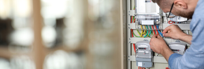 Man checking cables on electricity meter indoors, closeup. Banner design