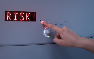 Woman pressing button Analysis, closeup. Knob with scale of risk