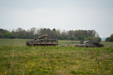 British army Challenger 2 II FV4034 main battle tank with Warrior FV510 IFV in action on a military exercise