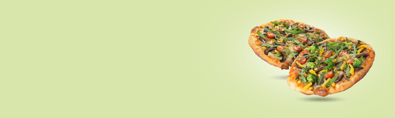 Different delicious pizzas in air on light green background. Banner design with space for text
