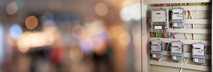 Electricity meters and wires in fuse box indoors. Banner design