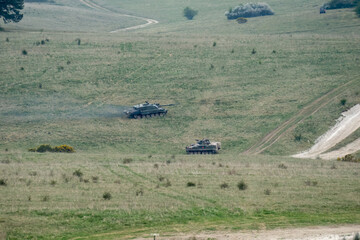 British army Challenger 2 II FV4034 main battle tank with Warrior FV510 IFV in action on a military exercise