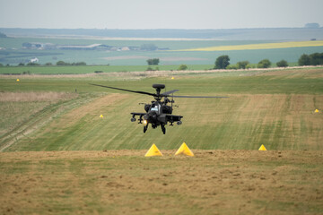 close-up front view of a hovering Boeing Apache Attack helicopter AH2 AH64E AH-64E ArmyAir gunship