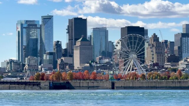 Montreal, Canada - October 08, 2025: Montreal skyline photographed from Parc Jean-Drapeau. The St. Lawrence River in the foreground.