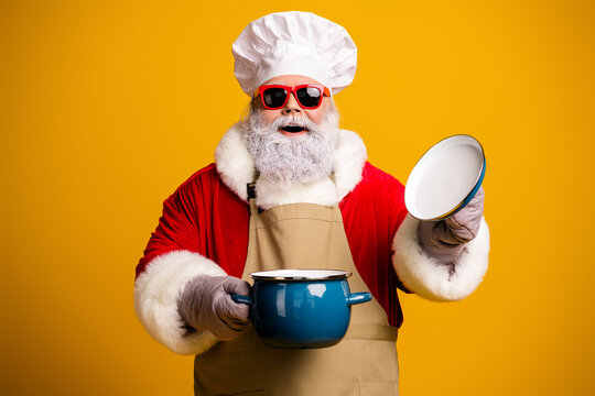 Smiling Santa Claus chef in festive attire holding a pot, expressing joy and humor against a bright yellow backdrop