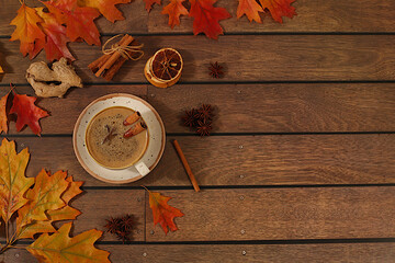 Seasonal abstract composition with hot autumn drink, coffee with foam, masala chai and fallen leaves, star anise and cinnamon, banner for screen, autumn greeting concept, mockup for menu.