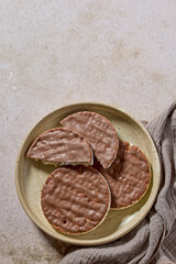 plate of rice galettes cakes cookies covered with milk chocolate