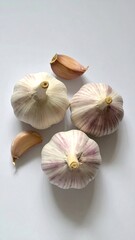 Garlic Bulbs and Cloves on White Background.