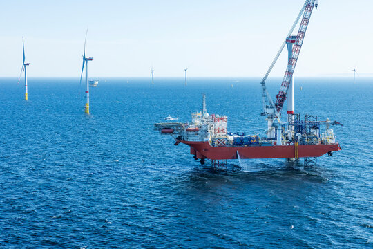 Wind farm installation ship in the Baltic Sea with helicopter on the helicopter landing pad.